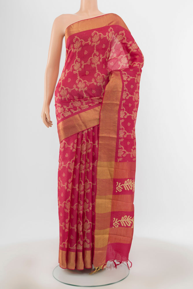 Peach Tussar Silk Saree with Floral Print on the body and Silk Border.  displayed on a mannequin