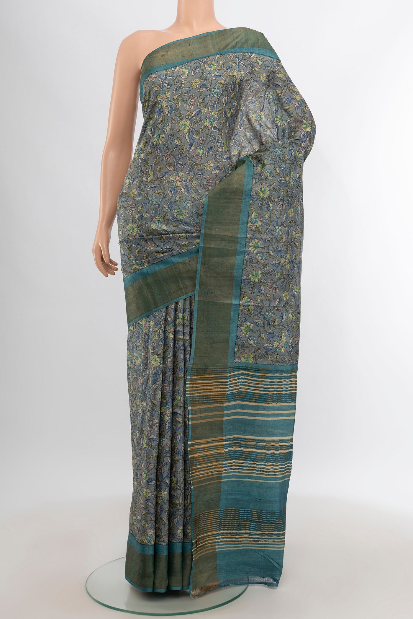 Davys Grey Tussar Silk Saree with Floral Print on the body and Zari Border.  displayed on a mannequin