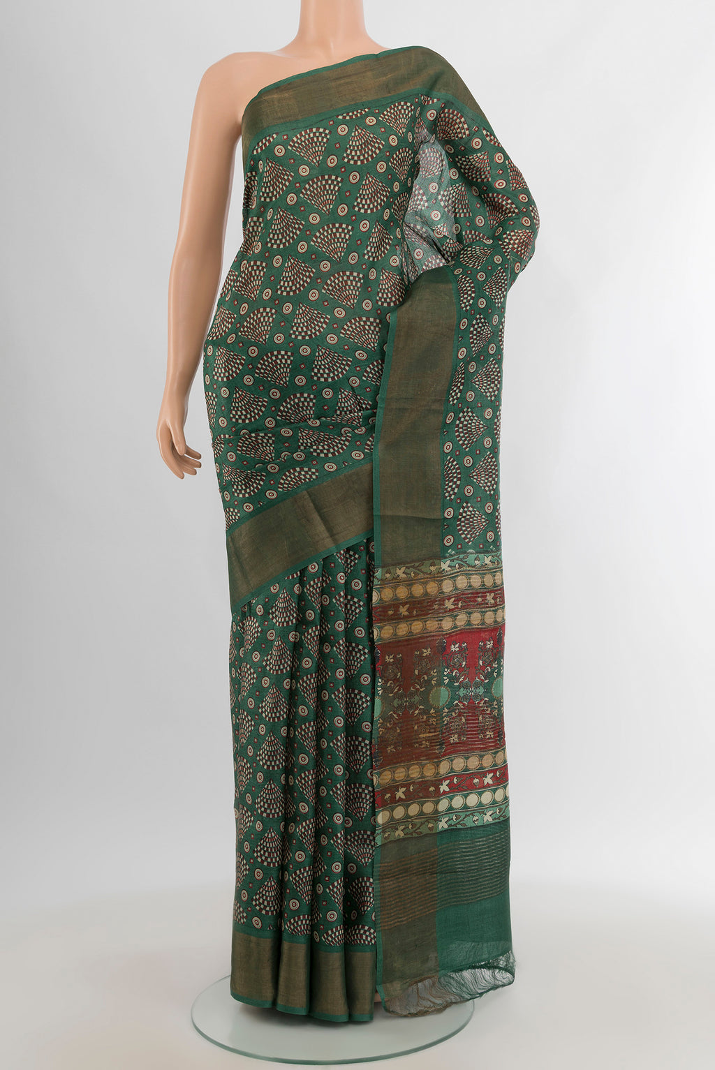 Green Tussar Silk Saree with Floral Print on the body and Zari Border.  displayed on a mannequin