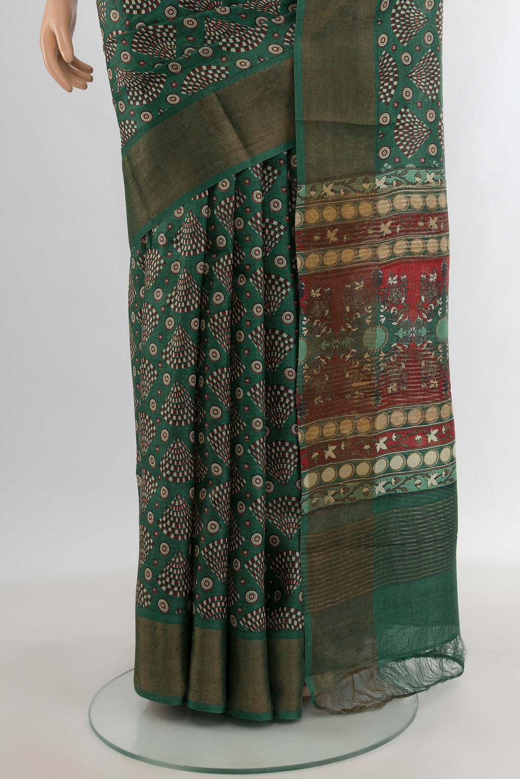 Pleats and pallu of Green Tussar Silk Saree with Floral Print on the body and Zari Border. 