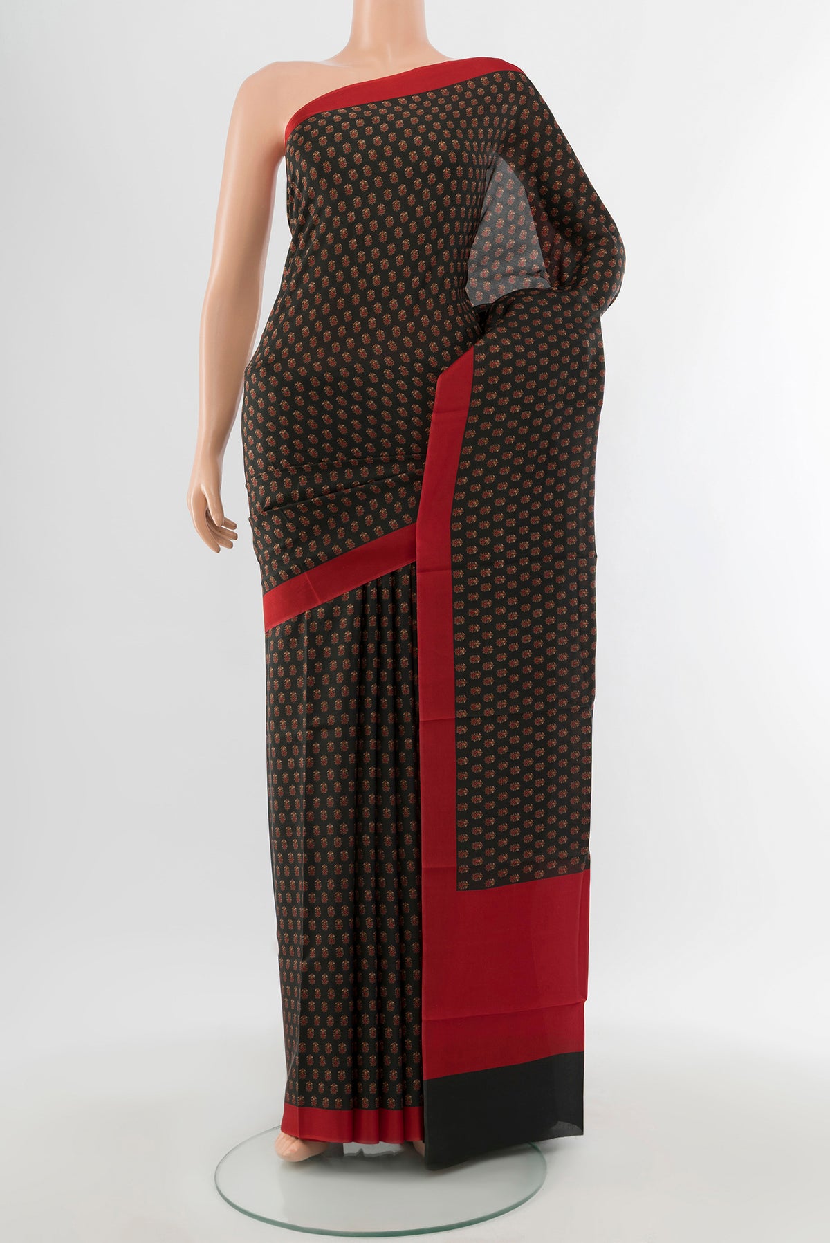 Black Printed Silk Saree with Floral Print on the body and Printed Border.  displayed on a mannequin