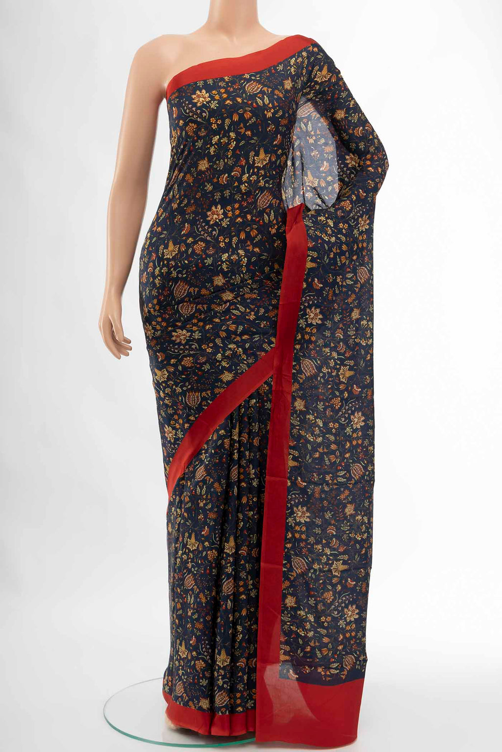 Navy Blue Printed Silk Saree with Floral Print on the body and Fancy Border displayed on a mannequin