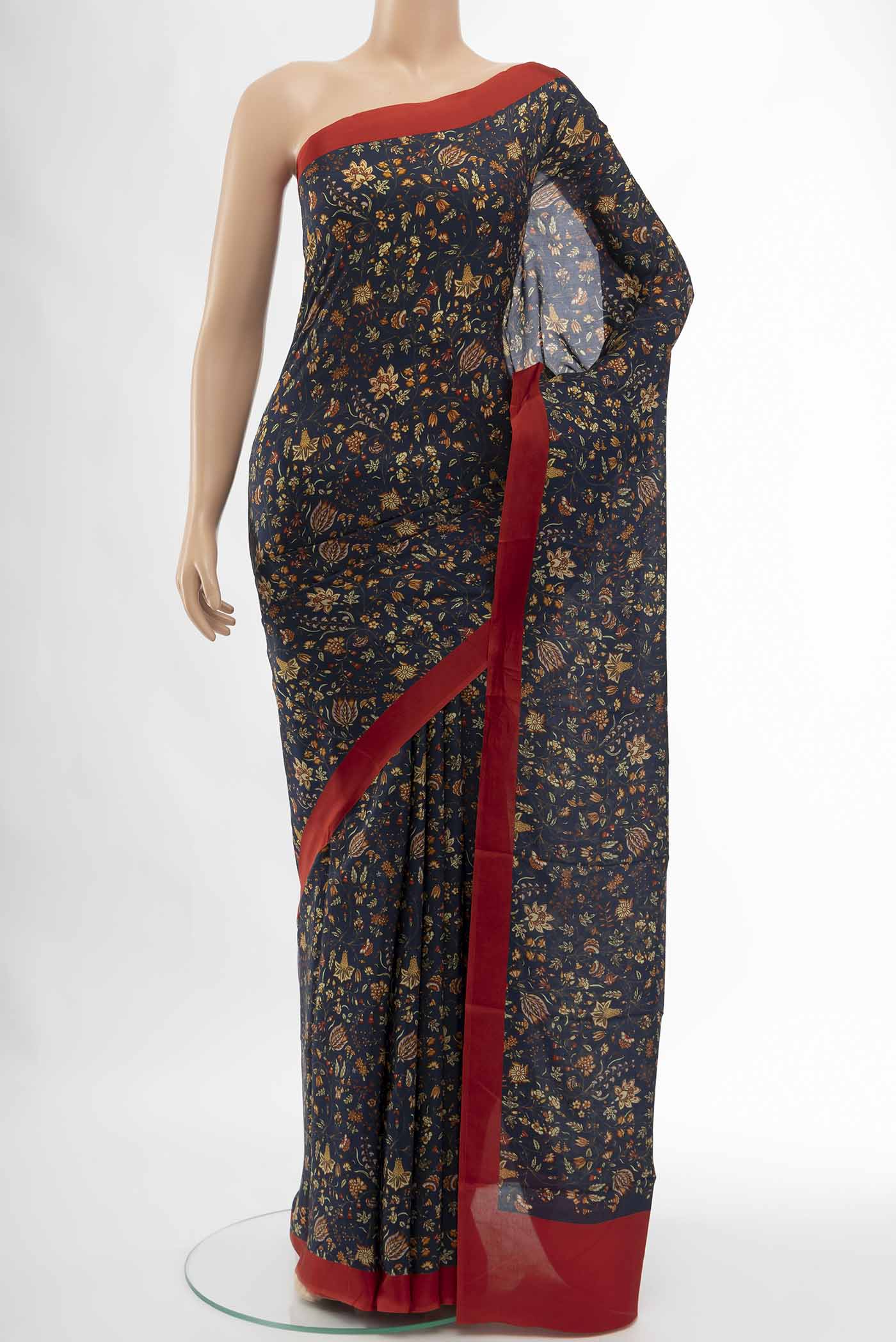 Navy Blue Printed Silk Saree with Floral Print on the body and Fancy Border displayed on a mannequin