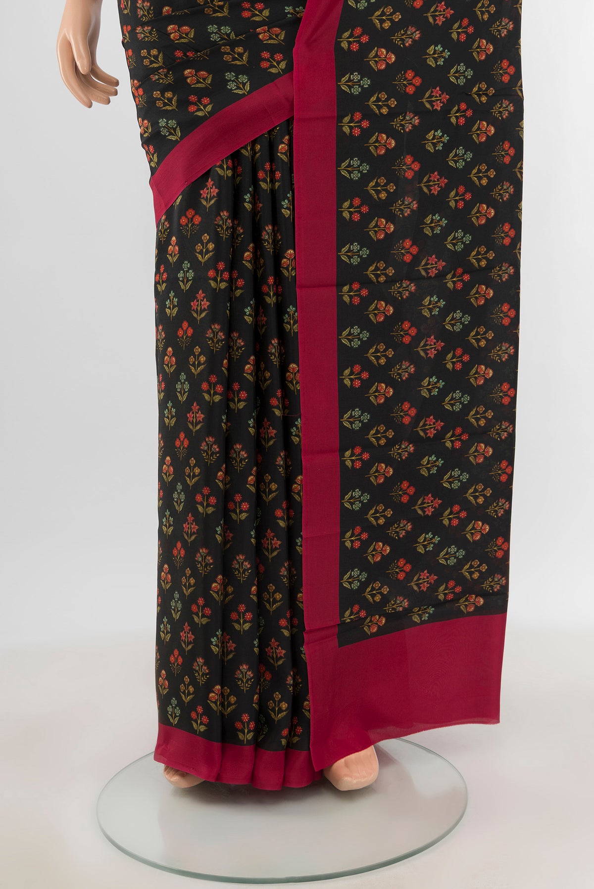 Pleats and pallu of Black Printed Silk Saree with Floral Print on the body and Printed Border. 