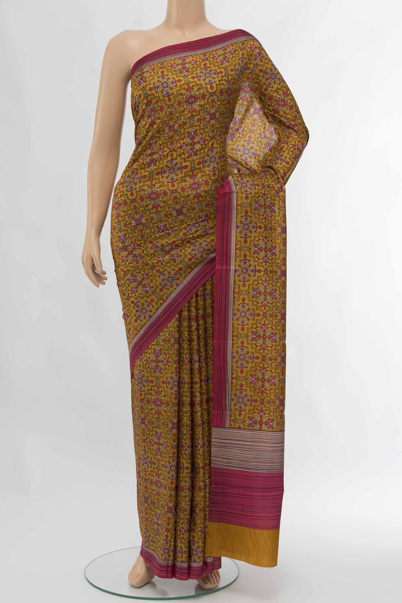 Rust Printed Silk Saree with Floral Print on the body and Silk Border displayed on a mannequin