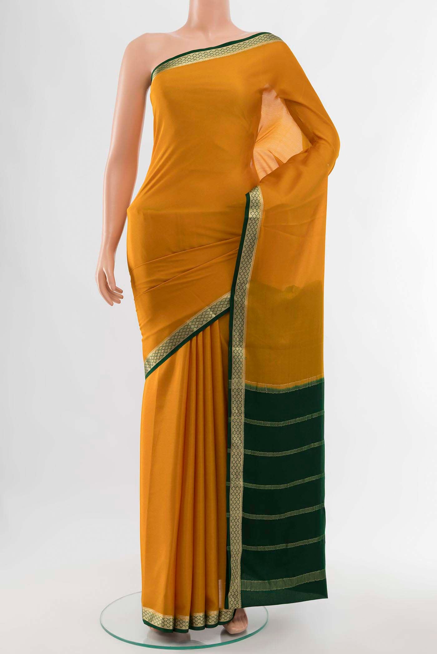 Mustard Mysore Crepe Saree with Zari Butta on the body and Zari Border displayed on a mannequin