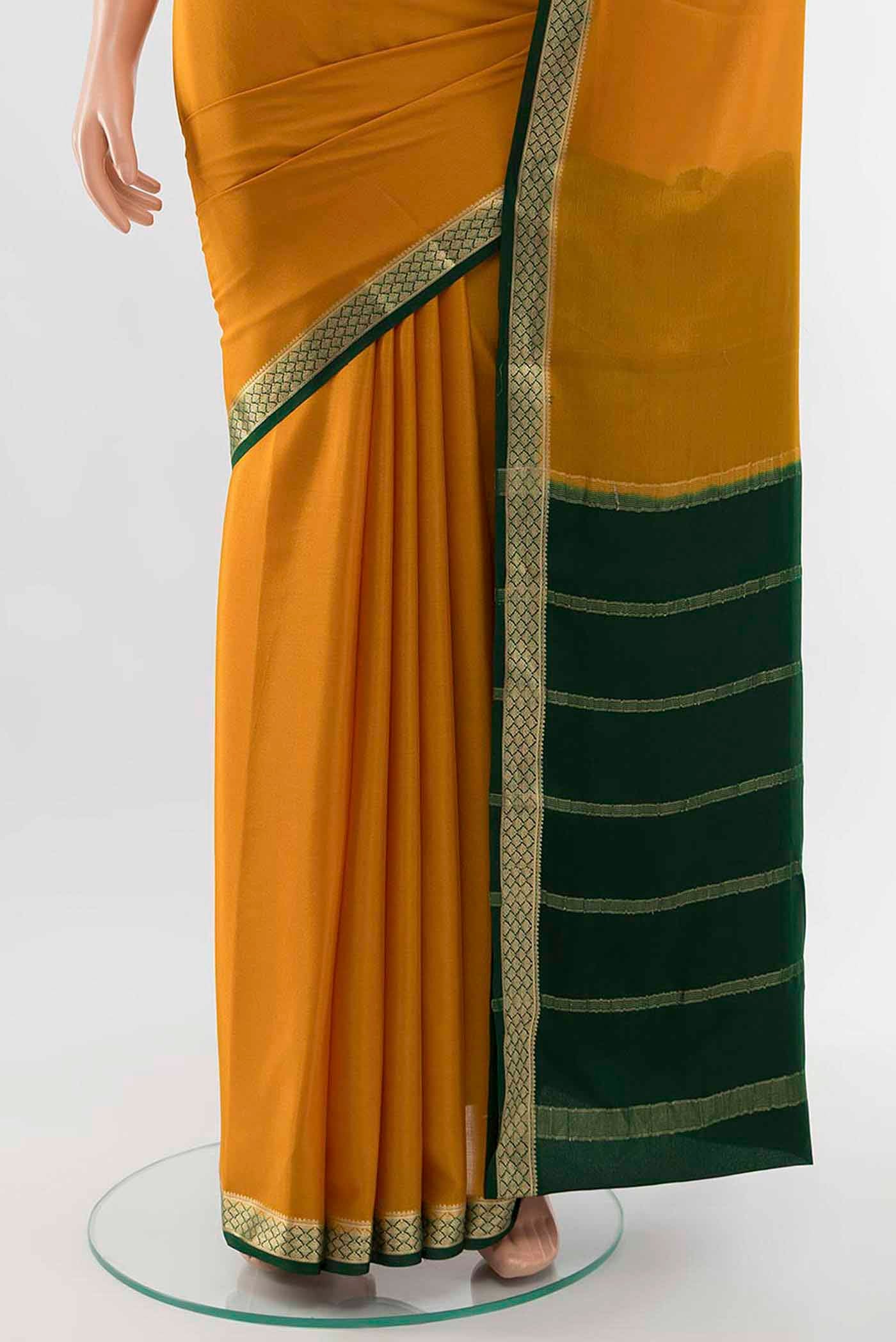 Pleats and pallu of Mustard Mysore Crepe Saree with Zari Butta on the body and Zari Border