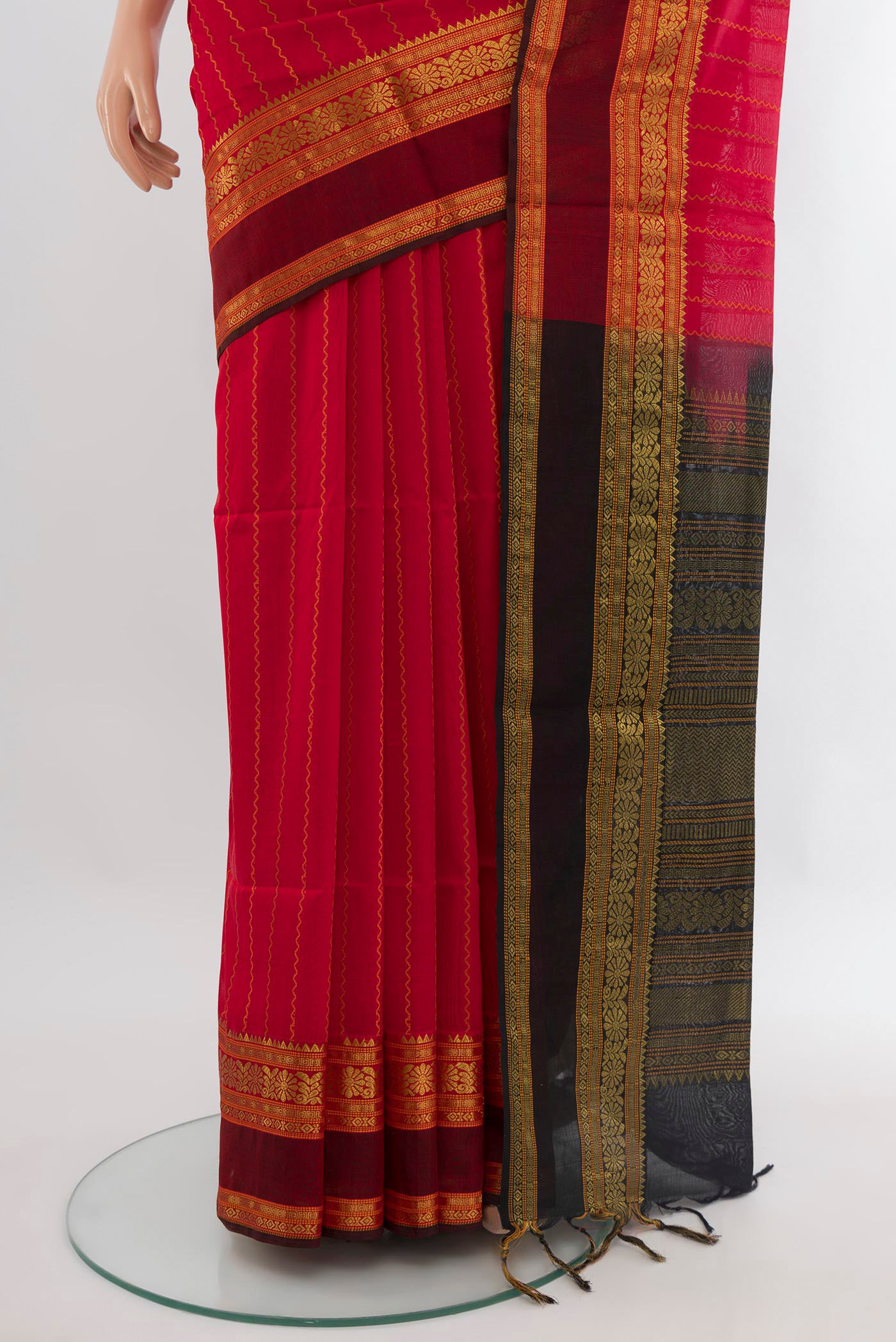 Pleats and pallu of Red Silk Cotton Saree with Stripes on the body and Zari Border. 