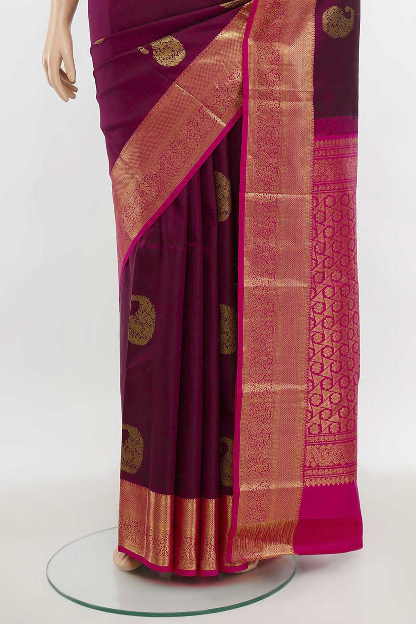 Pleats and pallu of Magenta Kanchipuram Silk Saree with Zari Butta on the body and Silk Border. 