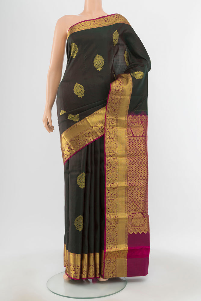 Pure Silk Pure Zari Mint Green Kanchipuram Saree with Zari Butta on the body and Silk Border.  displayed on a mannequin