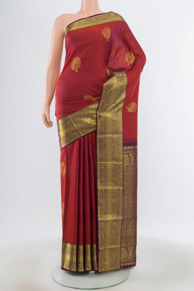 Maroon Kanchipuram Silk Saree with Plain Body and Silk Border.  displayed on a mannequin