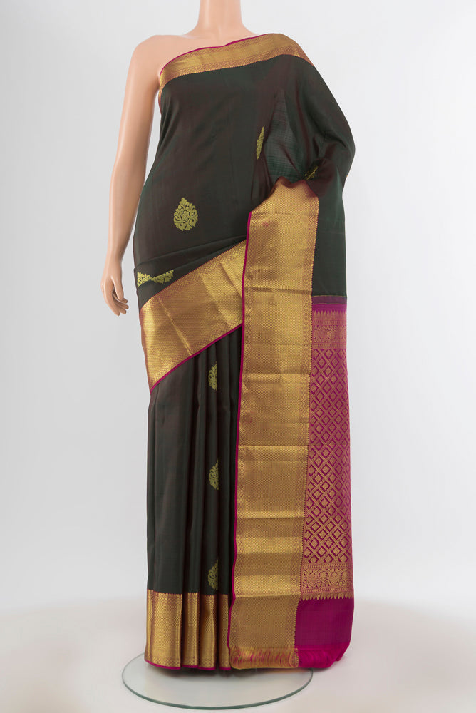 Pure Silk Pure Zari Mint Green Kanchipuram Saree with Zari Butta on the body and Silk Border.  displayed on a mannequin