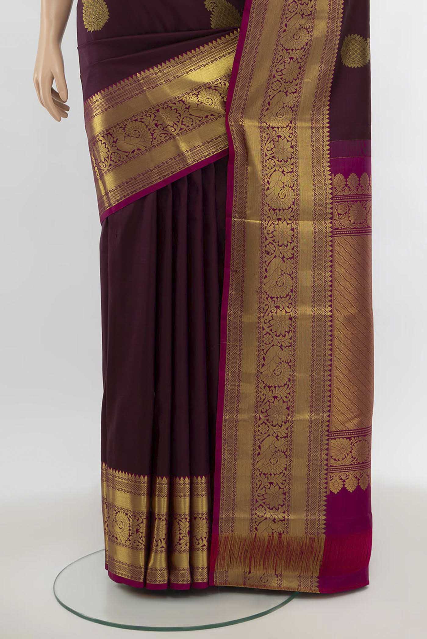Pleats and pallu of Coffee Brown Kanchipuram Silk Saree with Zari Butta on the body and Silk Border. 