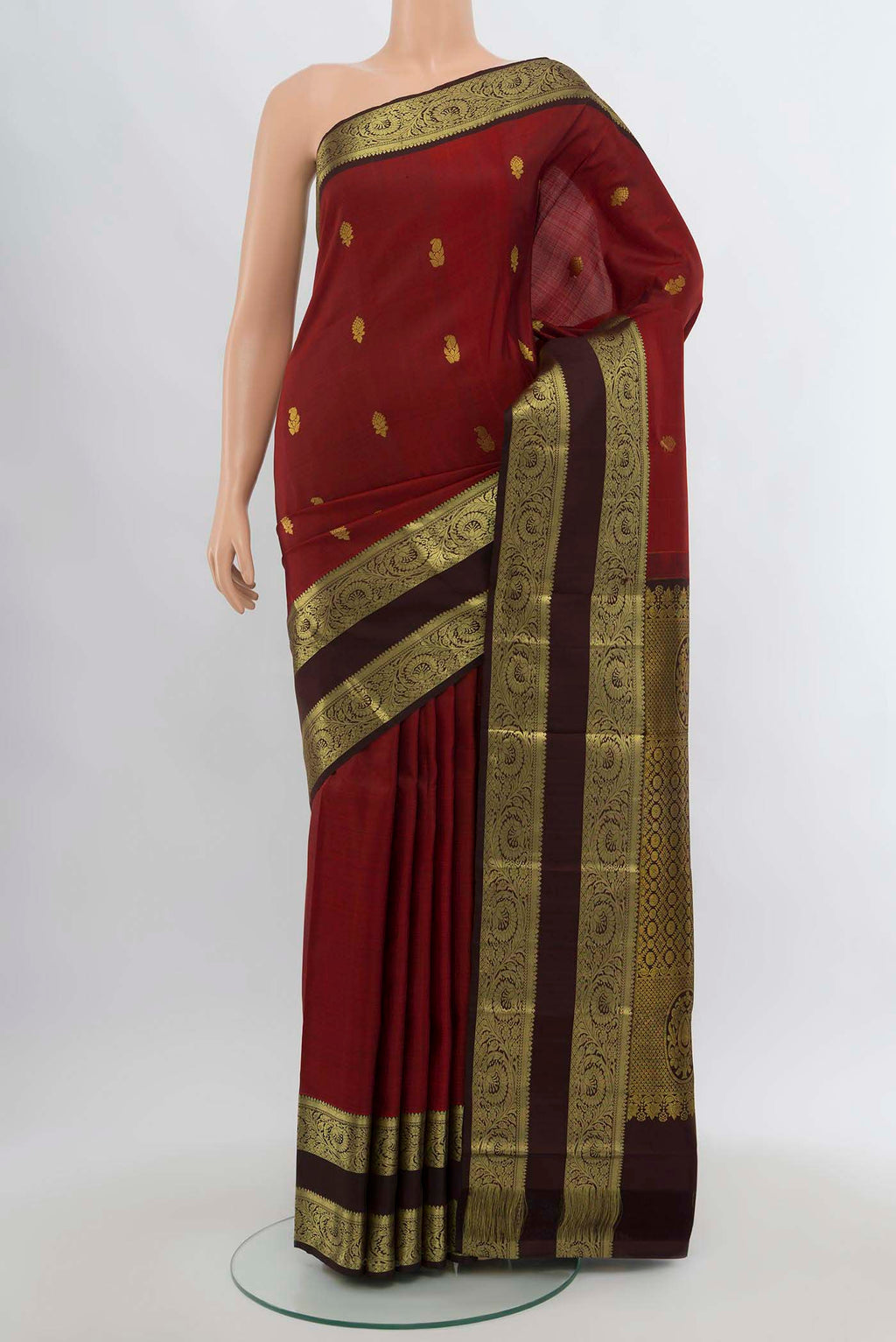 Maroon Kanchipuram Silk Saree with Zari Butta on the body and Silk Border.  displayed on a mannequin