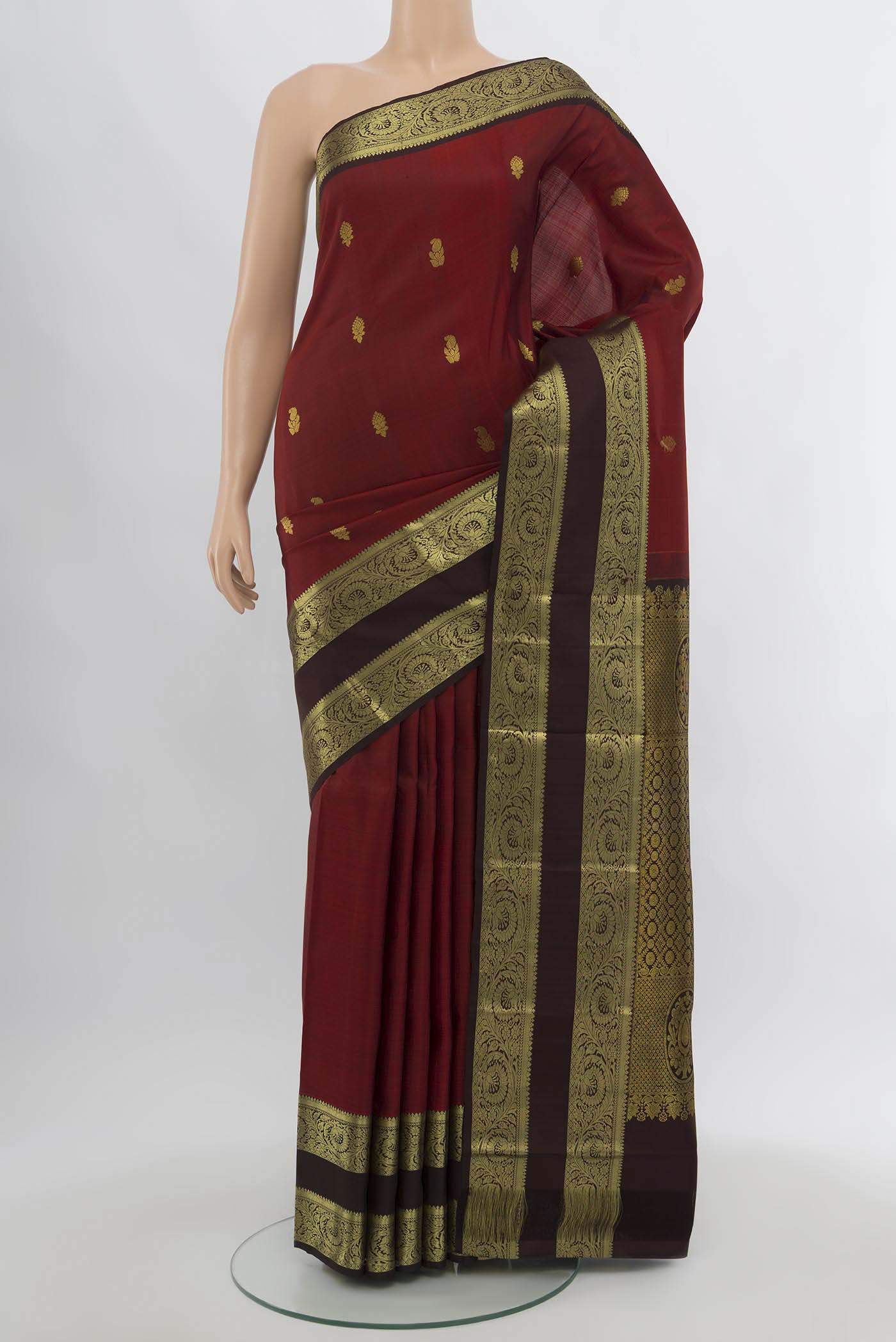 Maroon Kanchipuram Silk Saree with Zari Butta on the body and Silk Border.  displayed on a mannequin