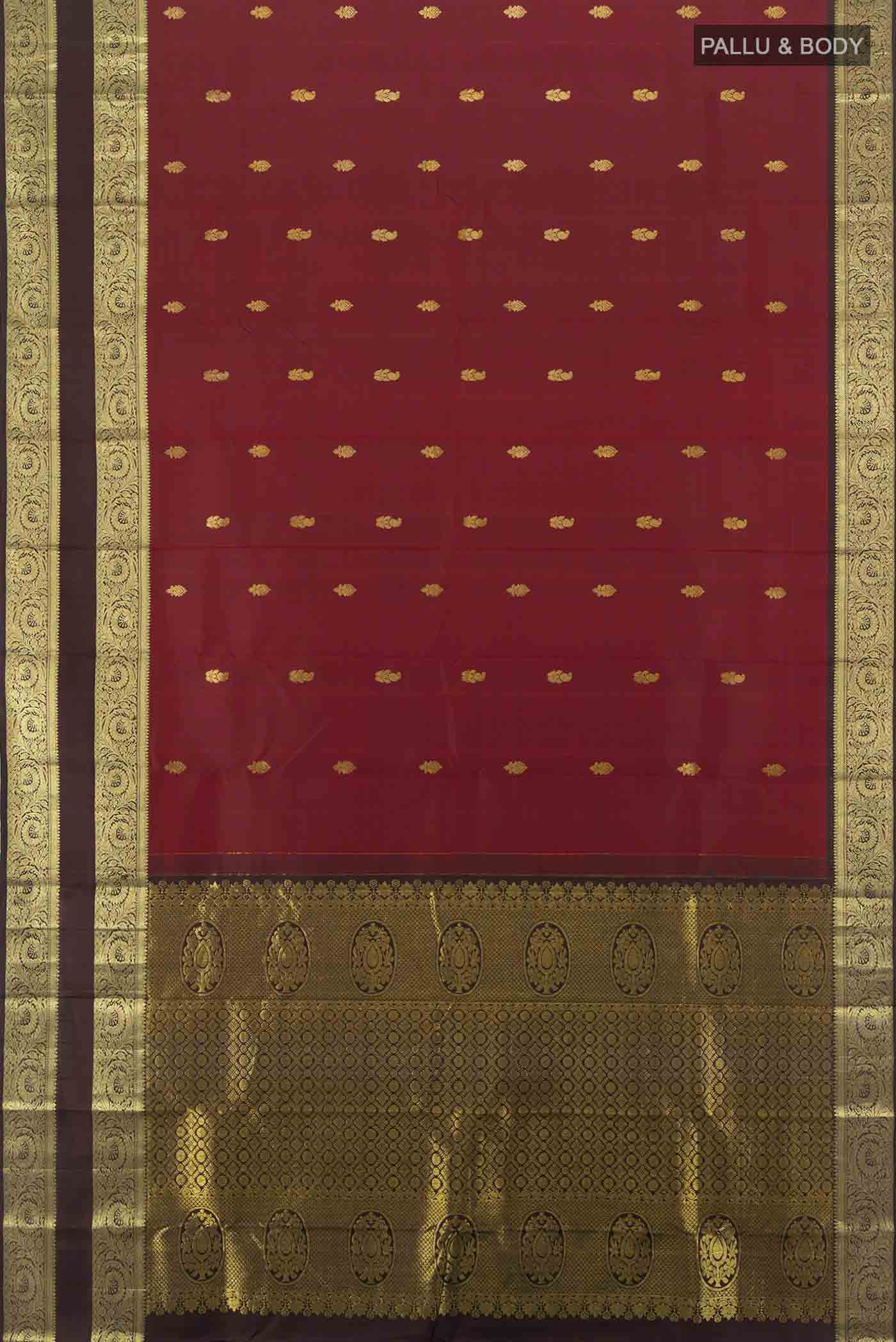 Flat view of Maroon Kanchipuram Silk Saree with Zari Butta on the body and Silk Border. 