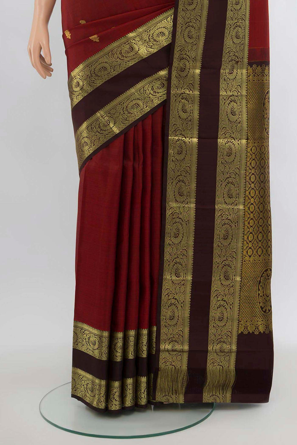 Pleats and pallu of Maroon Kanchipuram Silk Saree with Zari Butta on the body and Silk Border. 