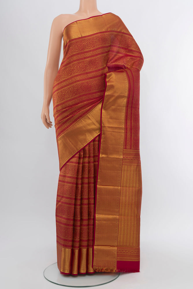 Maroon Kanjivaram Silk Saree with Zari Butta on the body and Silk Border.  displayed on a mannequin