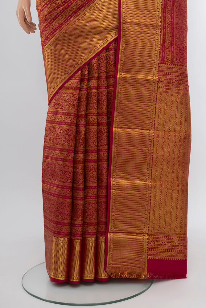 Pleats and pallu of Maroon Kanjivaram Silk Saree with Zari Butta on the body and Silk Border. 