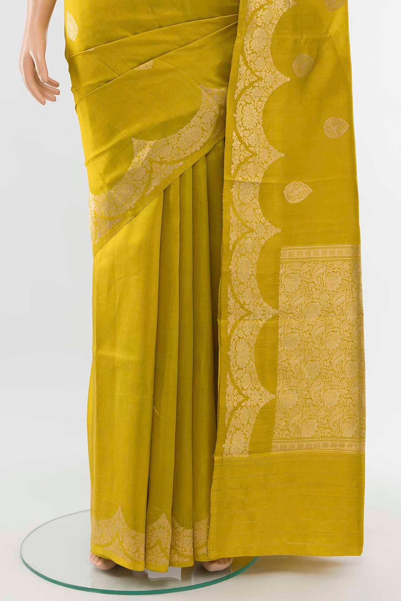 Pleats and pallu of Mehandi Green Banarasi Raw Silk Saree with Zari Butta on the body and Silk Border