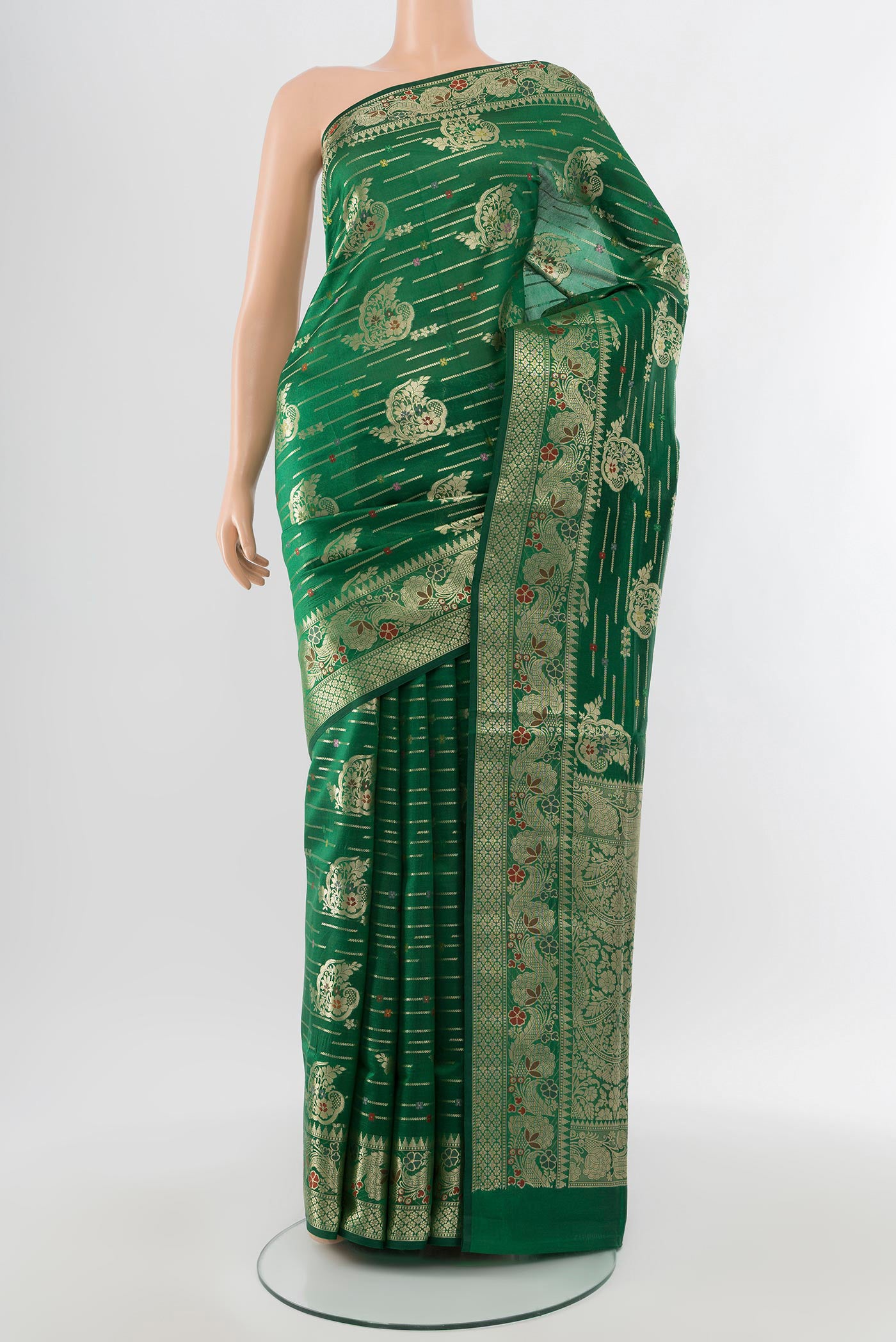Bottle Green Banarasi Raw Silk Saree with Zari Butta on the body and Silk Border.  displayed on a mannequin