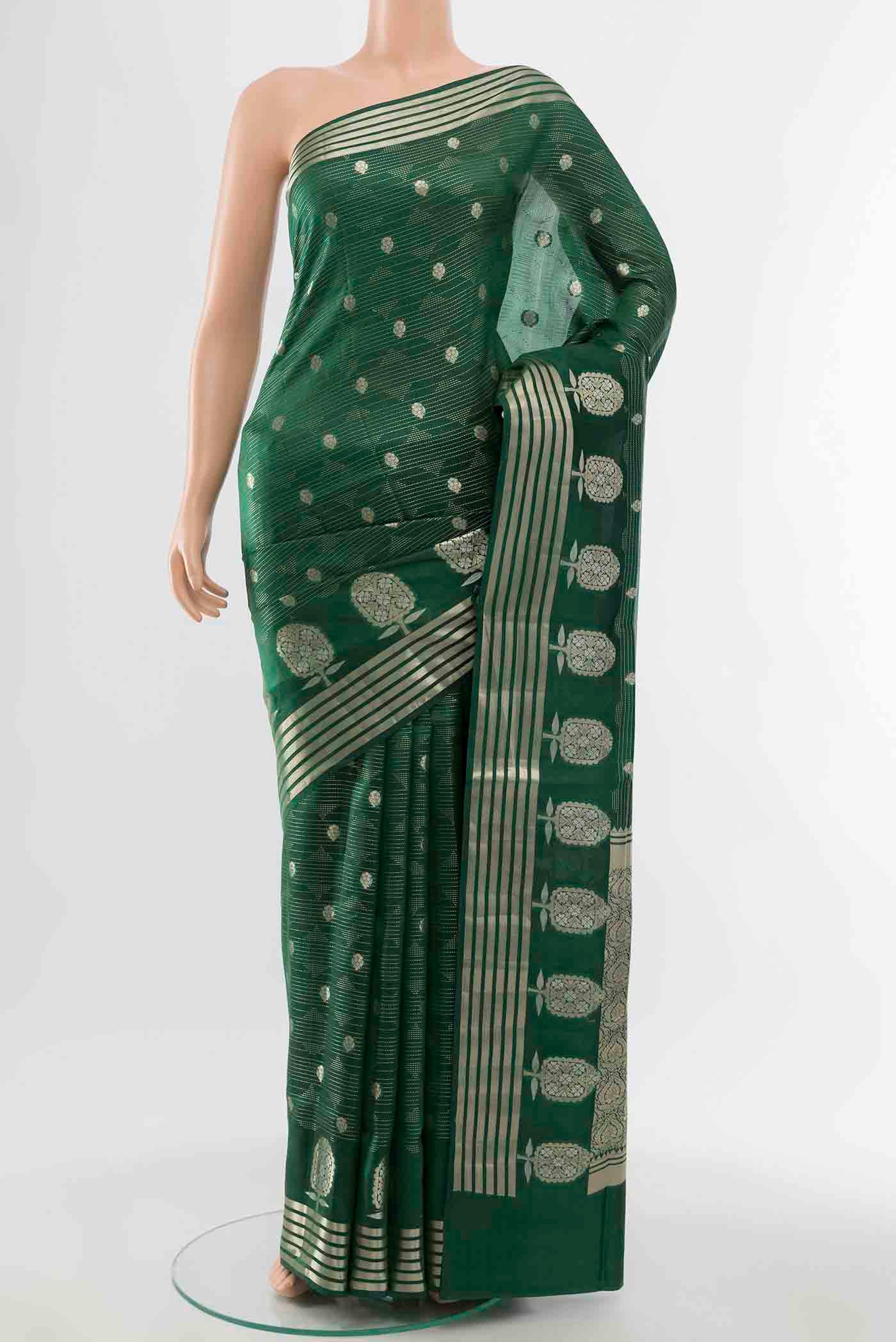 Bottle Green Banarasi Raw Silk Saree with Zari Butta on the body and Silk Border displayed on a mannequin