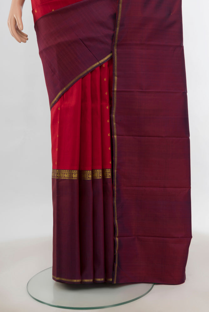 Pleats and pallu of Maroon Kanjivaram Silk Saree with Zari Butta on the body and Silk Border. 