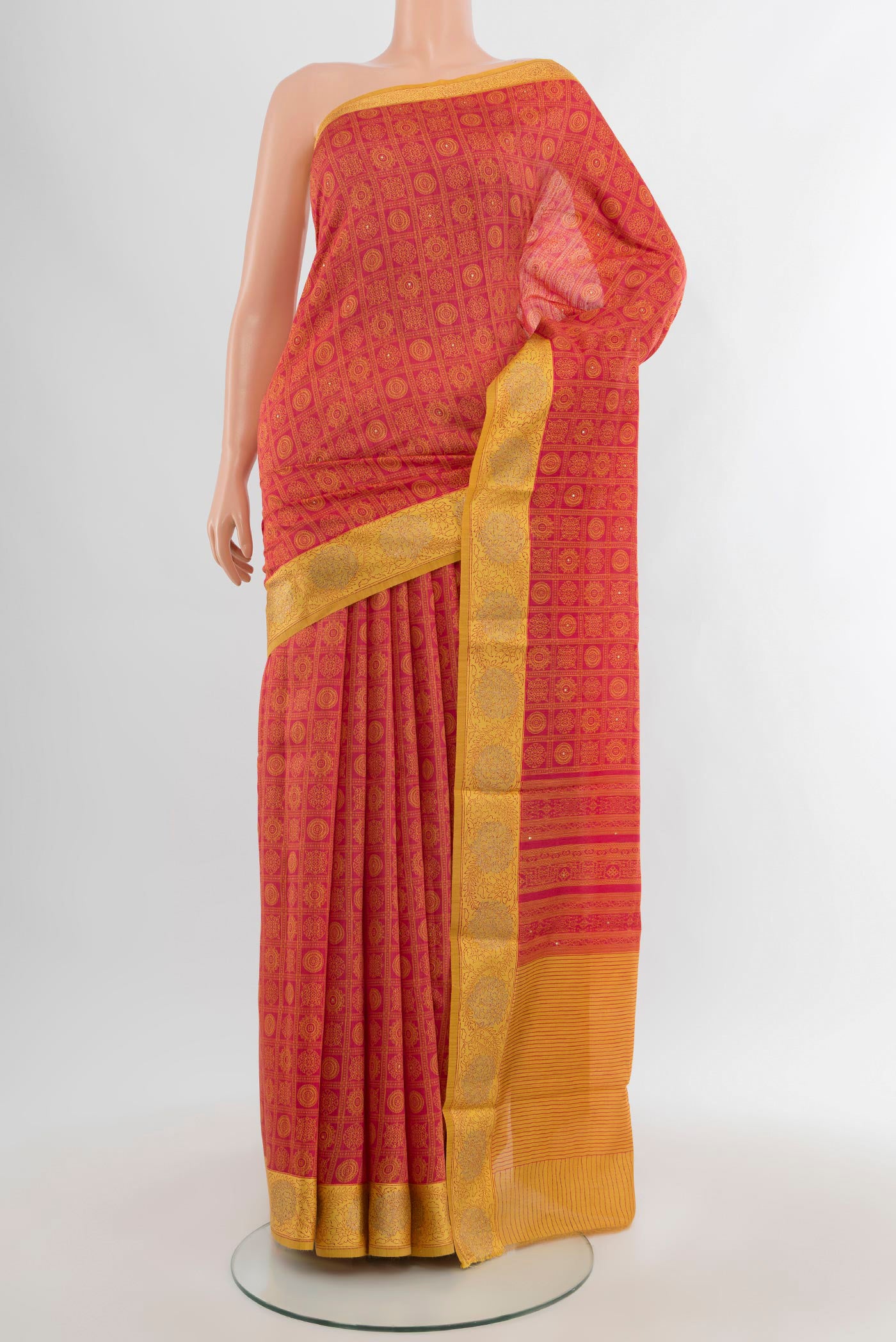 Red Tussar Silk Saree with Floral Print on the body and Embroidery Border.  displayed on a mannequin