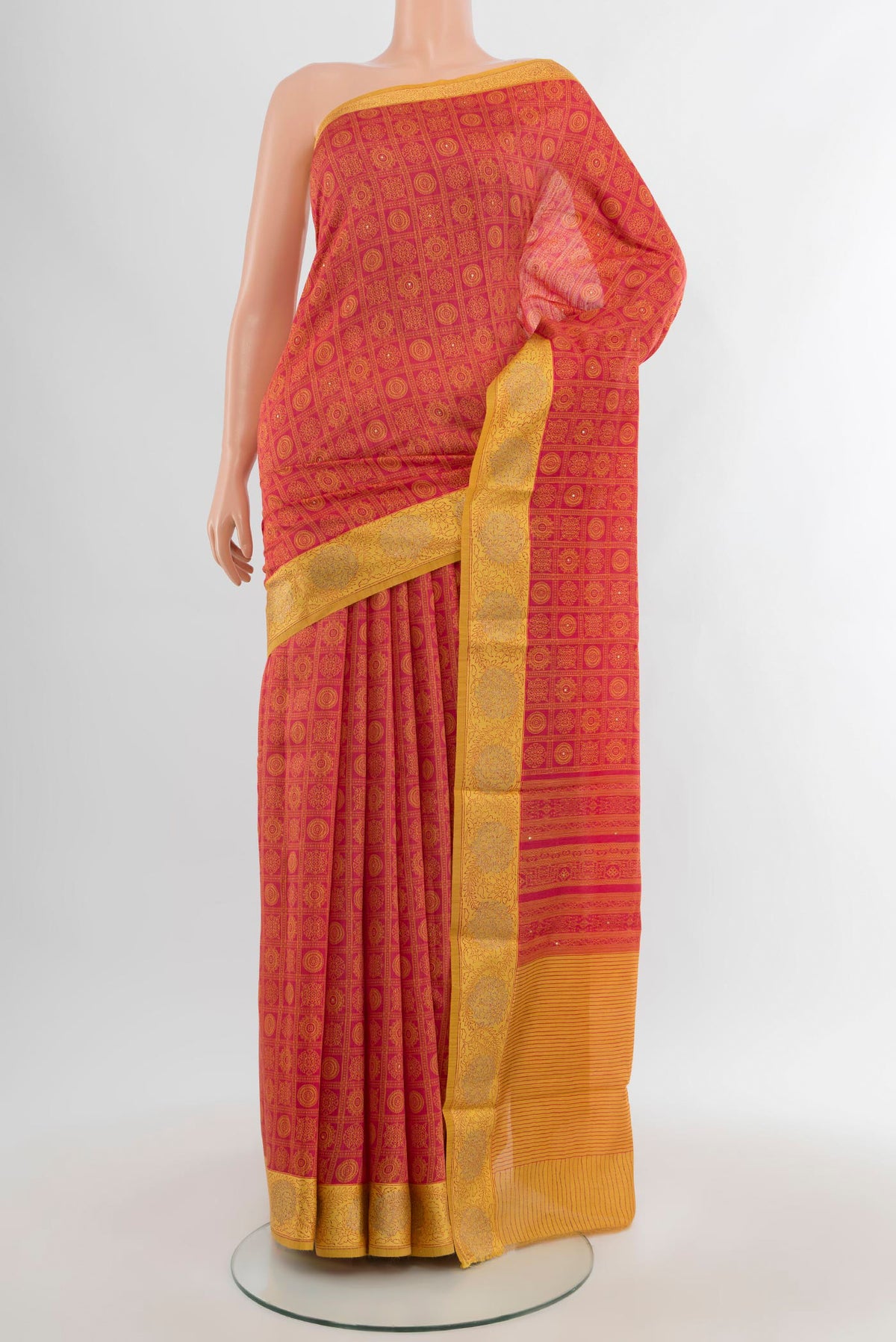 Red Tussar Silk Saree with Floral Print on the body and Embroidery Border.  displayed on a mannequin