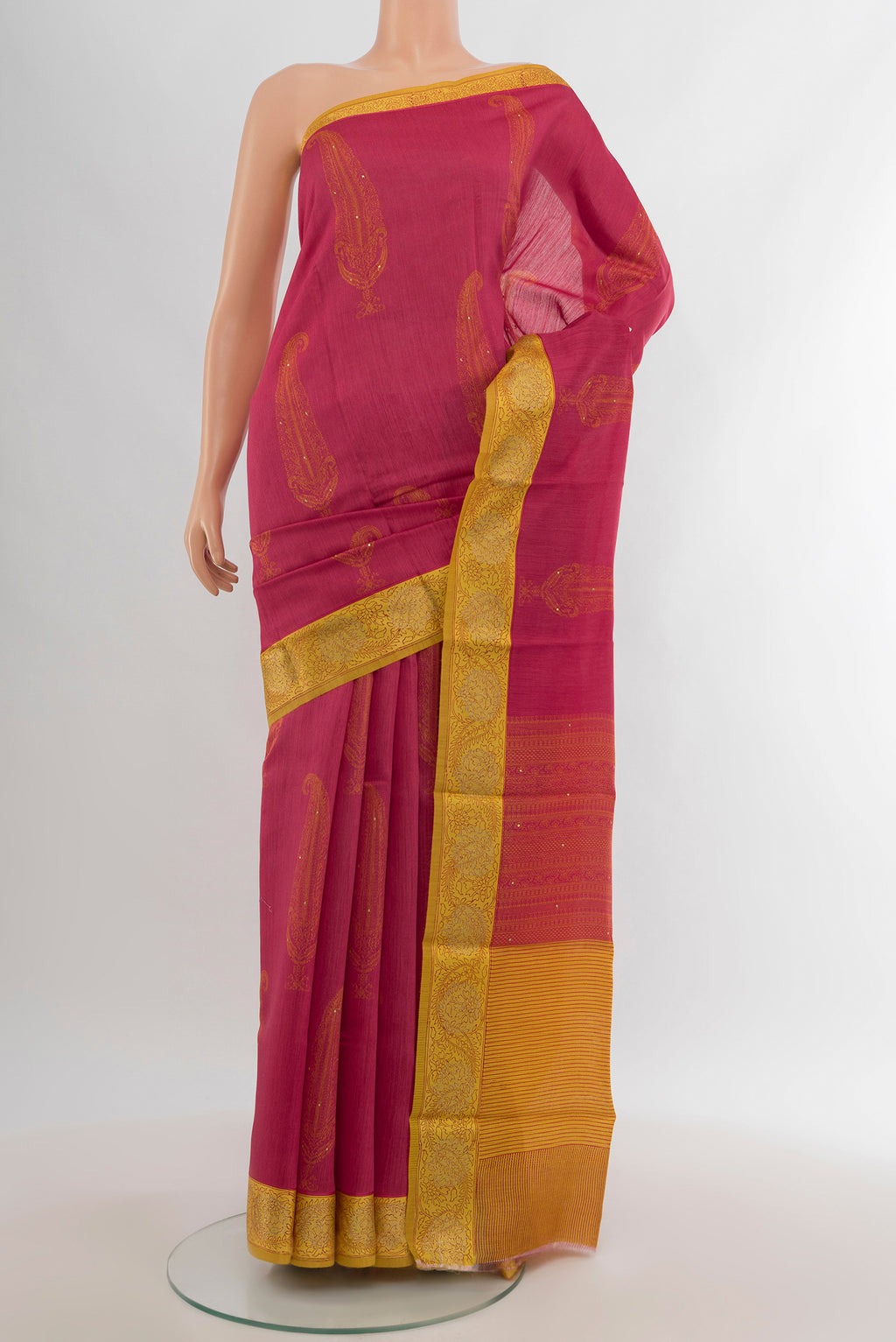 Pink Tussar Silk Saree with Floral Print on the body and Zari Border.  displayed on a mannequin