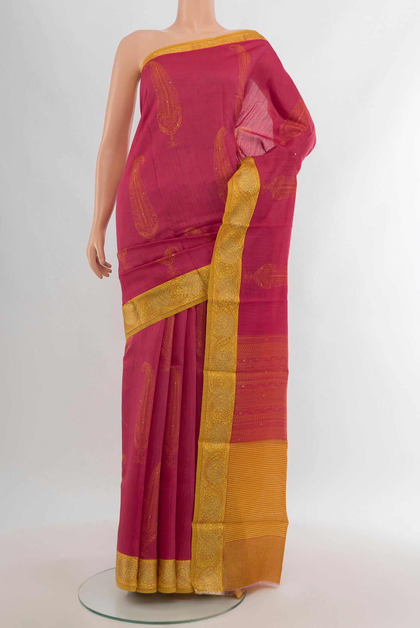 Pink Tussar Silk Saree with Floral Print on the body and Zari Border.  displayed on a mannequin