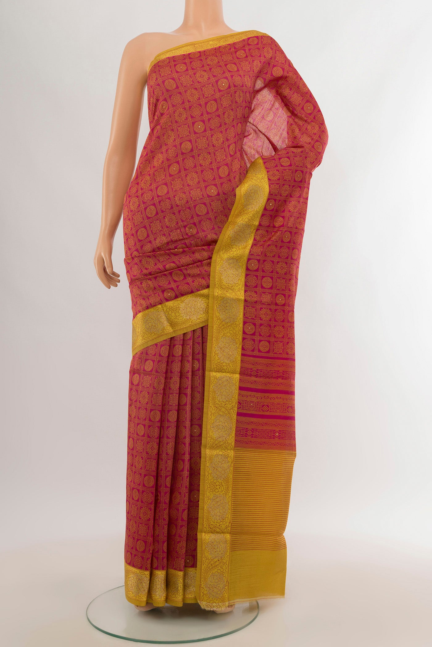 Pink Tussar Silk Saree with Floral Print on the body and Zari Border.  displayed on a mannequin