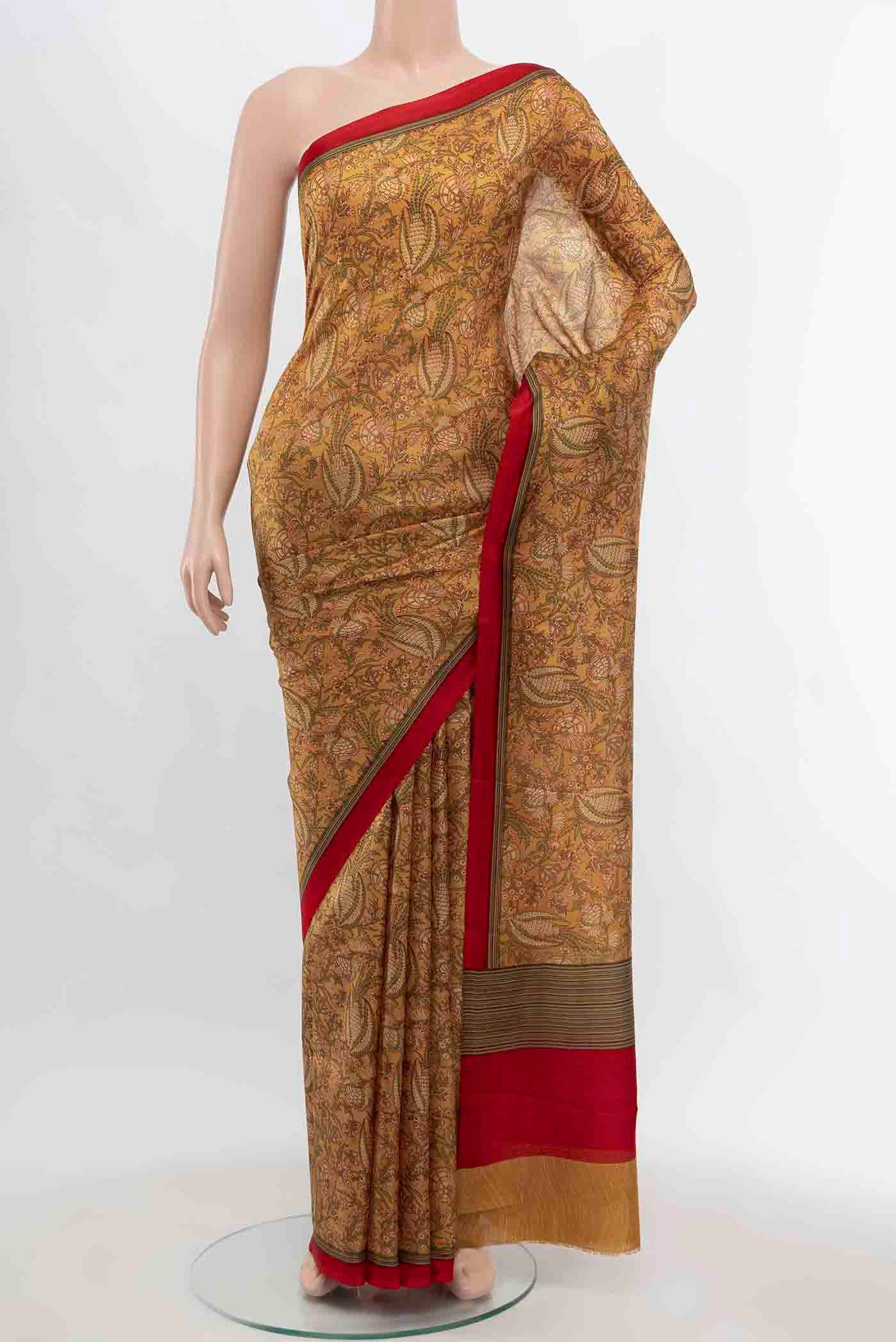 Beige Printed Silk Saree with Floral Print on the body and Fancy Border displayed on a mannequin