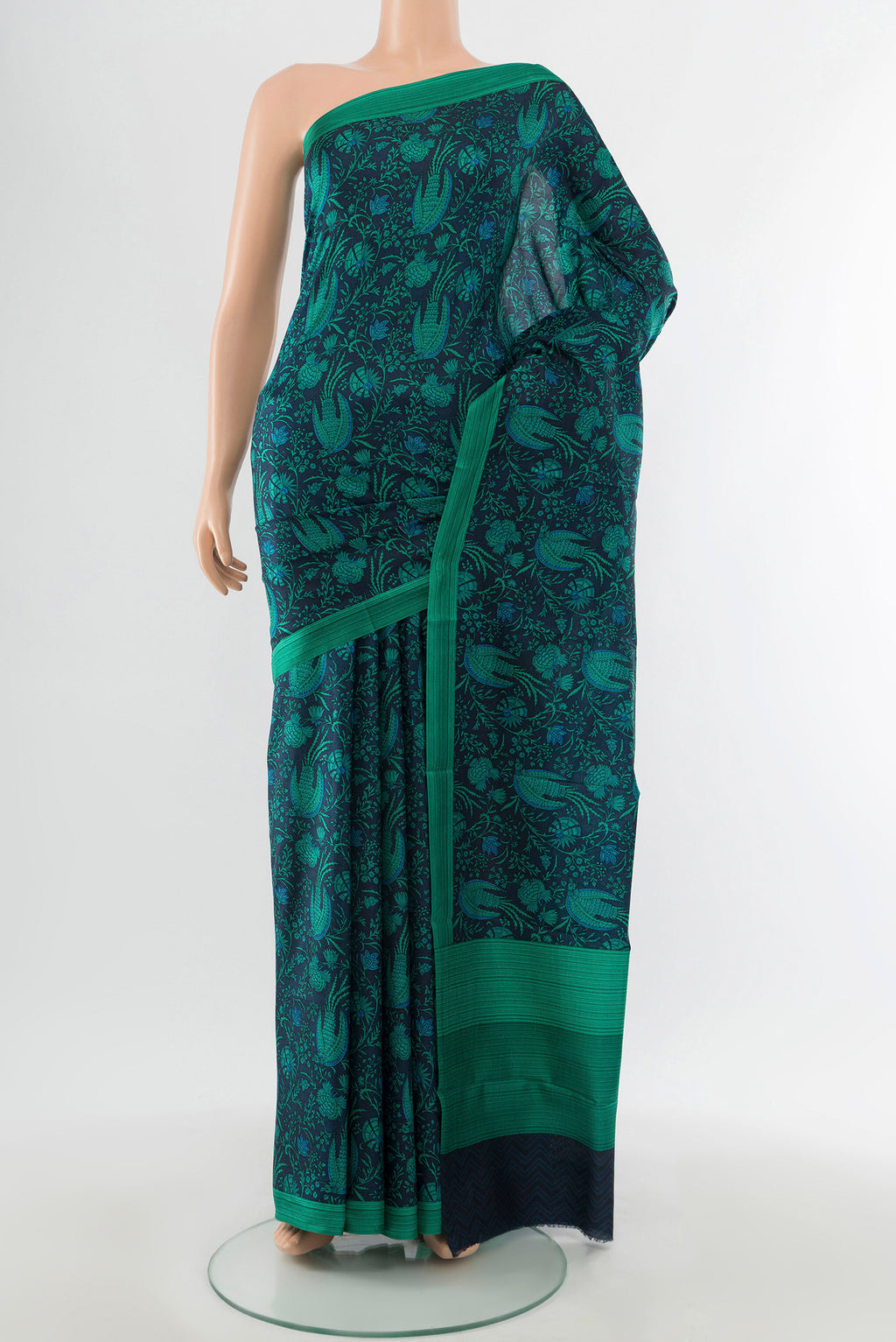 Navy Blue Printed Silk Saree with Floral Print on the body and Printed Border.  displayed on a mannequin