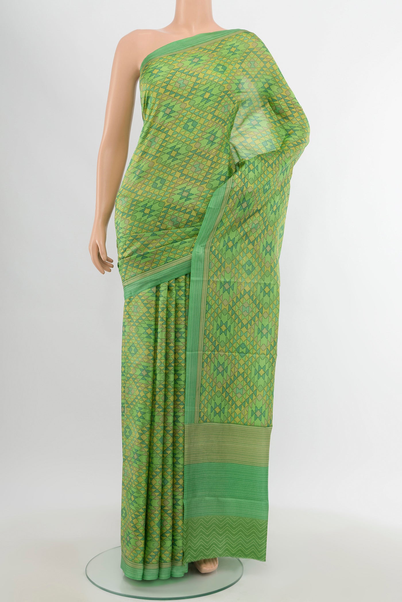Green Printed Silk Saree with Printed design on the body and Printed Border.  displayed on a mannequin