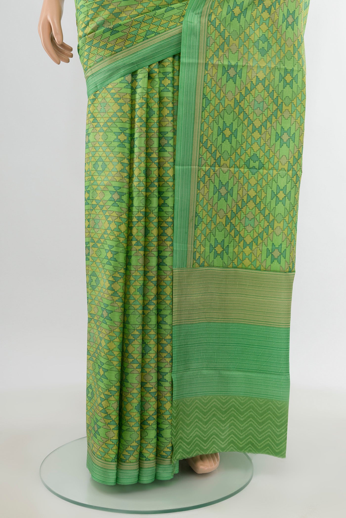 Pleats and pallu of Green Printed Silk Saree with Printed design on the body and Printed Border. 