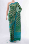 Green Printed Silk Saree with Floral Print on the body and Fancy Border displayed on a mannequin