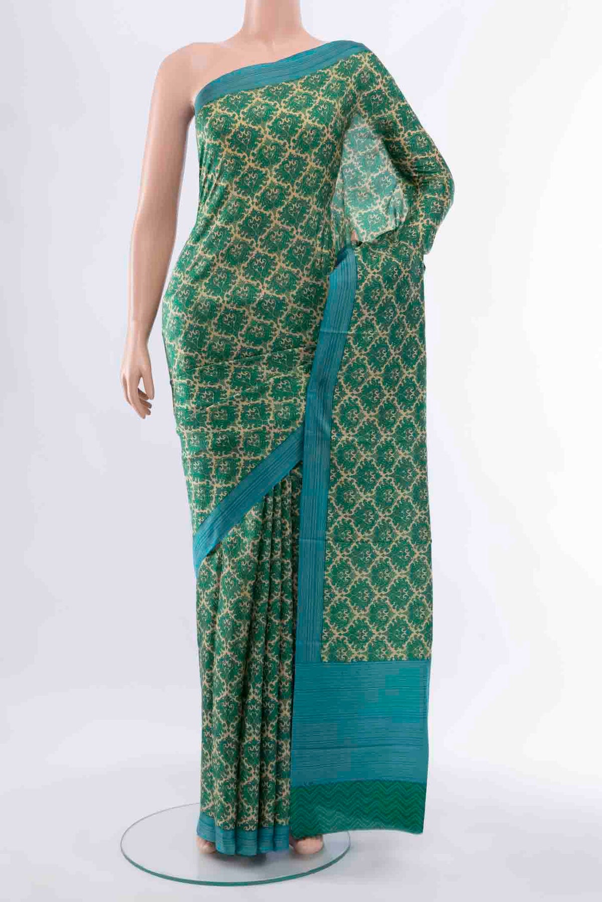 Green Printed Silk Saree with Floral Print on the body and Fancy Border displayed on a mannequin