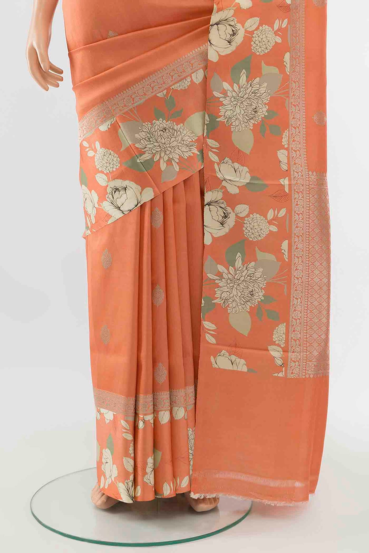 Pleats and pallu of Orange Tussar Silk Saree with Floral Print on the body and Silk Border