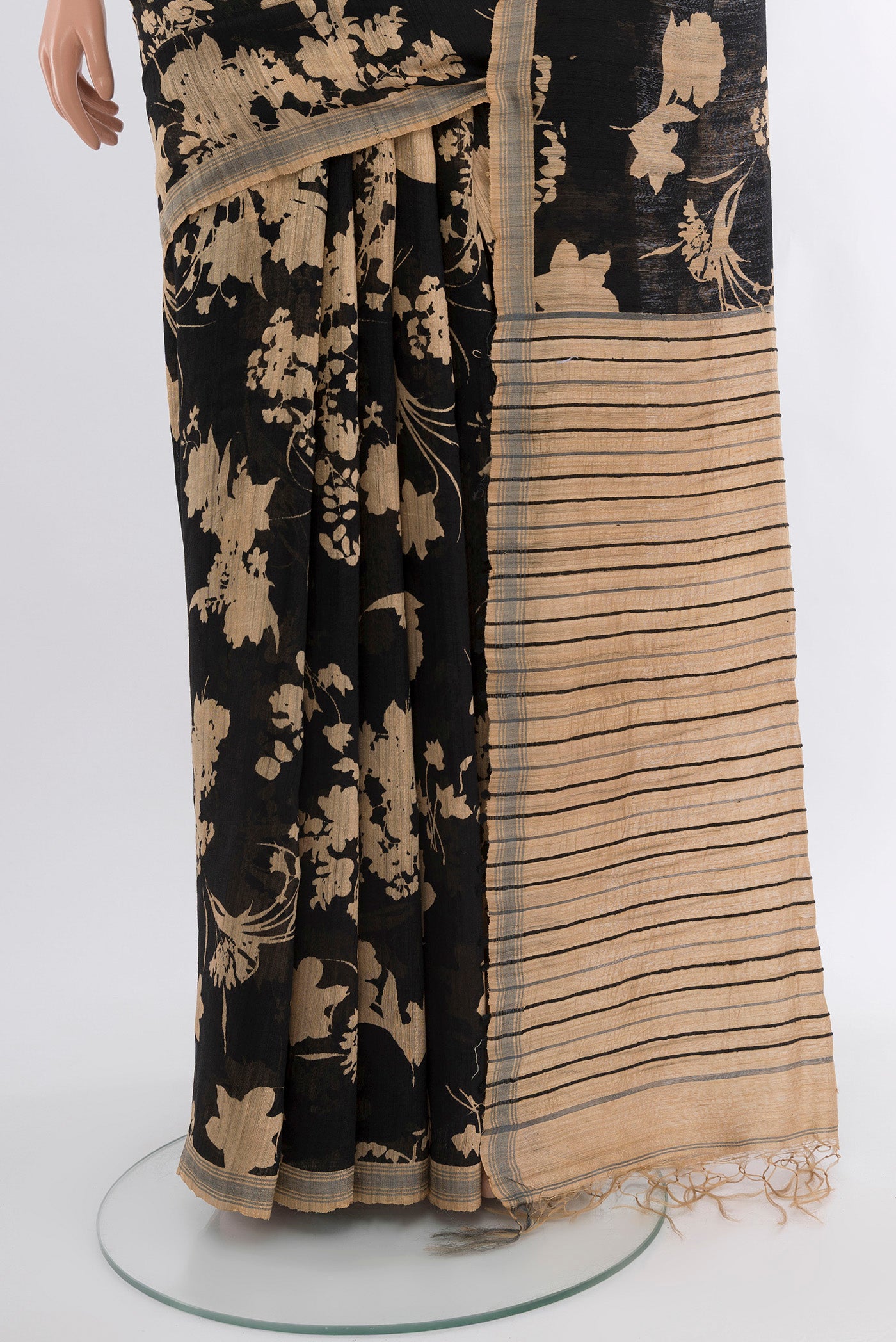 Pleats and pallu of Black Tussar Silk Saree with Floral Print on the body and Plain Border. 