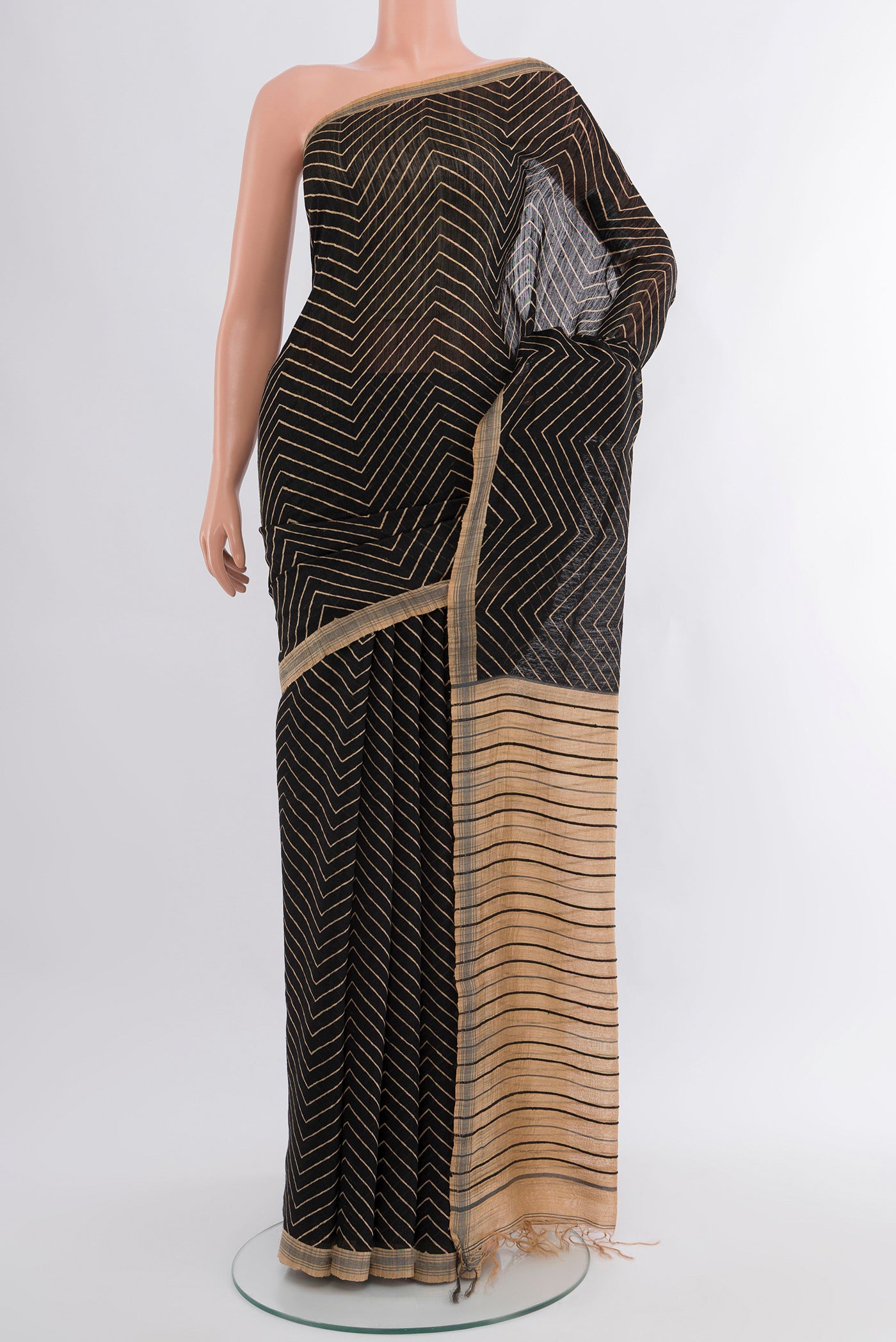 Black Tussar Silk Saree with Zig Zag design on the body and Plain Border.  displayed on a mannequin