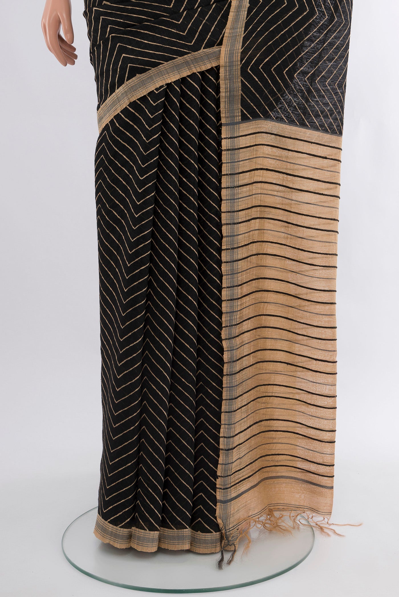 Pleats and pallu of Black Tussar Silk Saree with Zig Zag design on the body and Plain Border. 