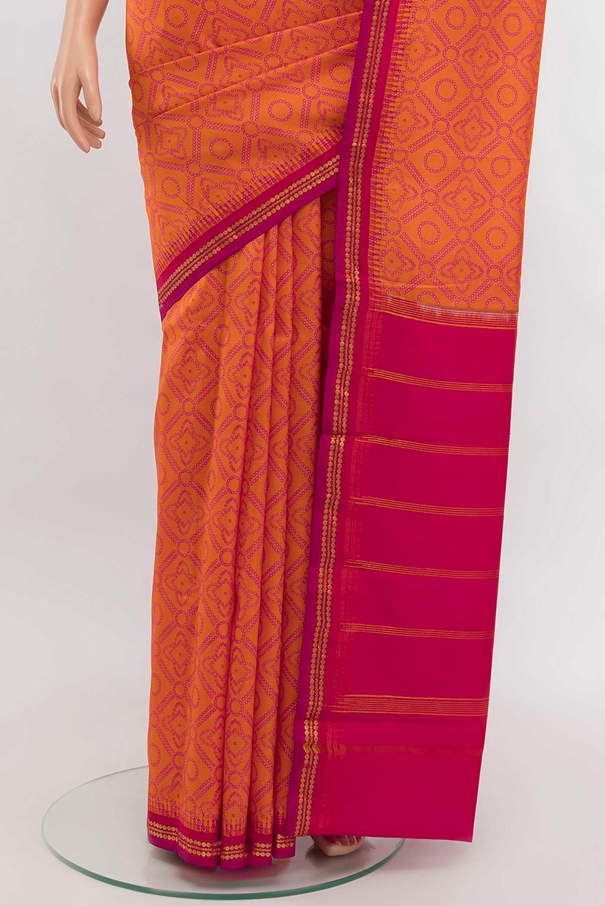 Pleats and pallu of Orange Printed Silk Saree with Zari Butta on the body and Silk Border
