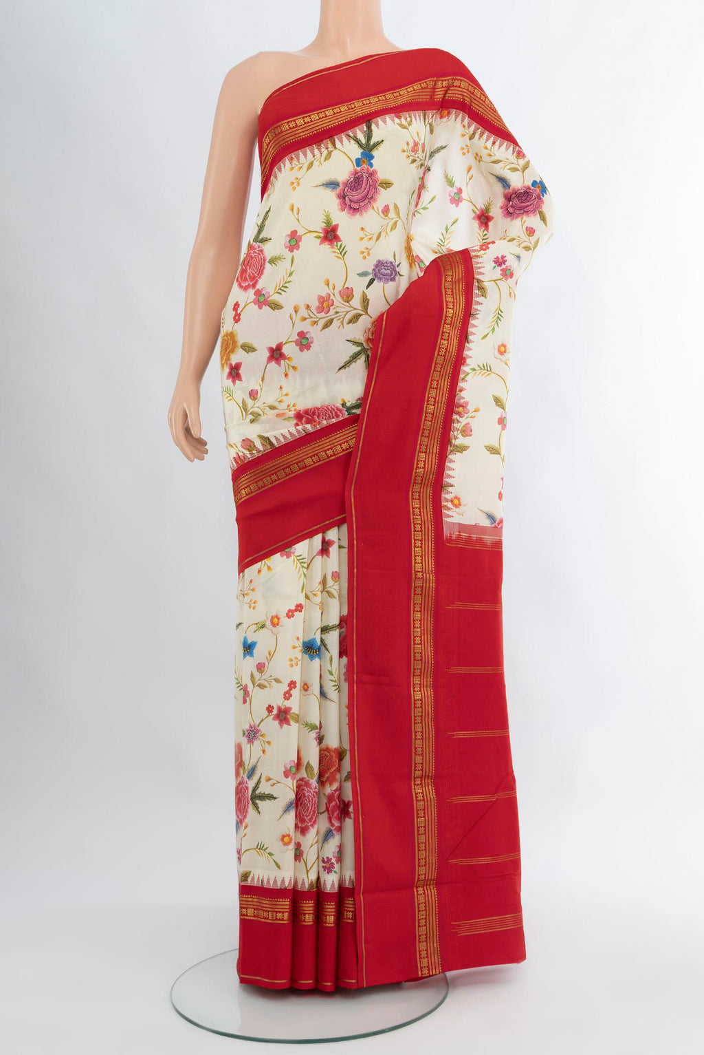 Off White Printed Silk Saree with Floral Print on the body and Zari Border.  displayed on a mannequin