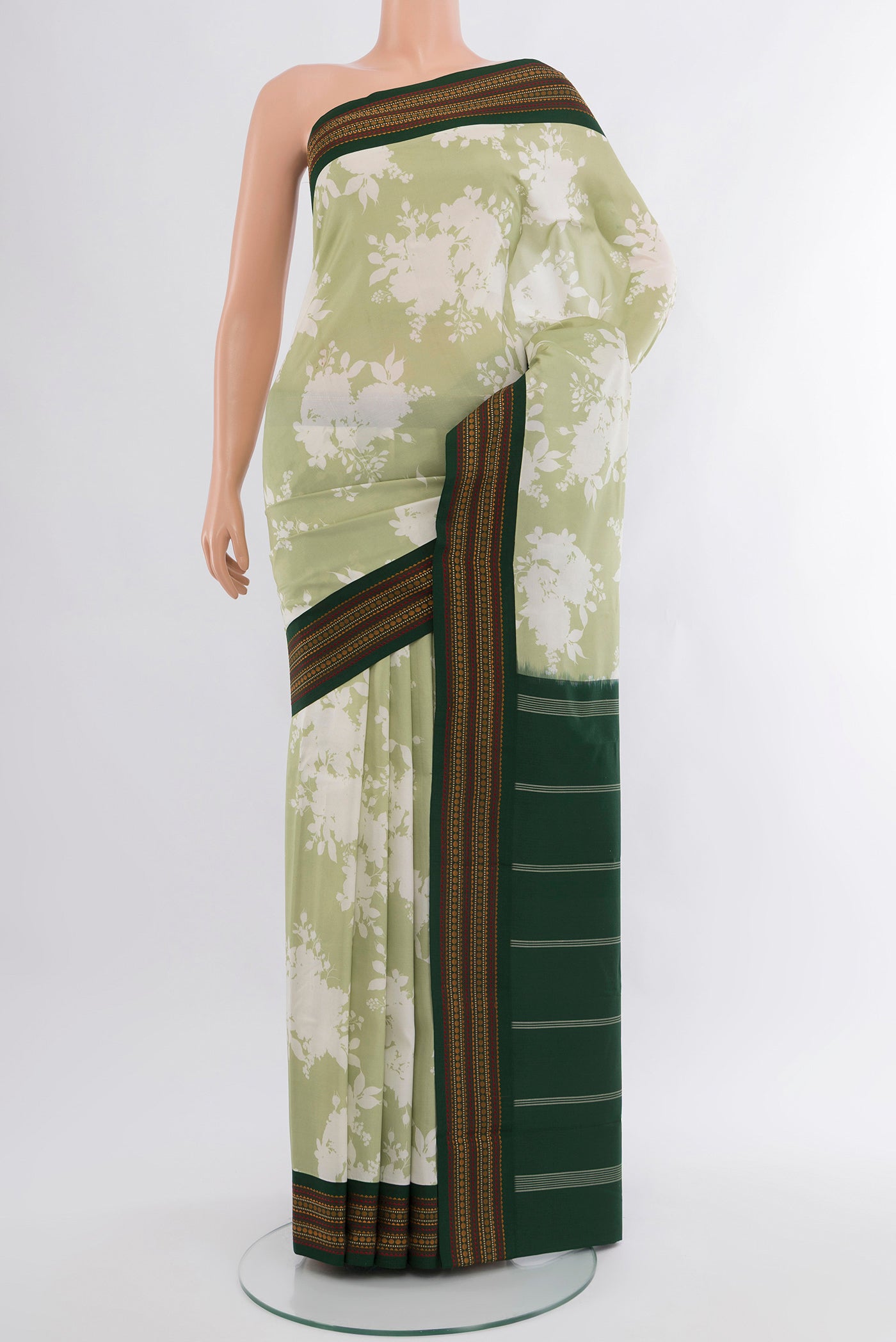 Pista Green Printed Silk Saree with Floral Print on the body and Zari Border.  displayed on a mannequin