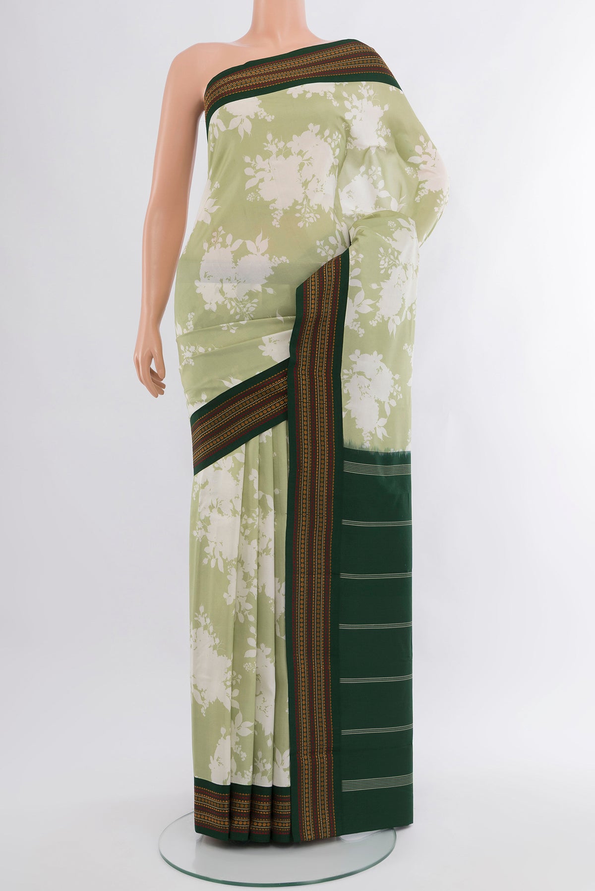 Pista Green Printed Silk Saree with Floral Print on the body and Zari Border.  displayed on a mannequin