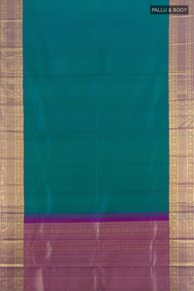 Flat view of Peacock Blue Kanjivaram Silk Saree with Zari Butta on the body and Silk Border. 