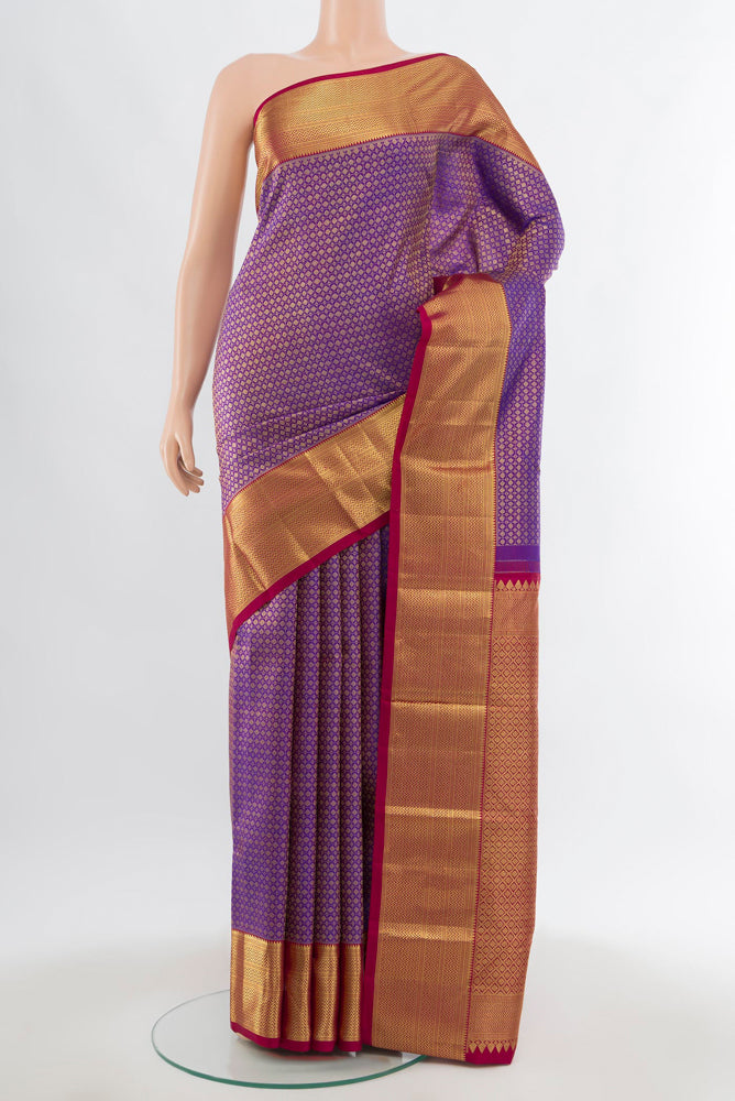 Purple Kanjivaram Silk Saree with Zari Brocade on the body and Silk Border.  displayed on a mannequin