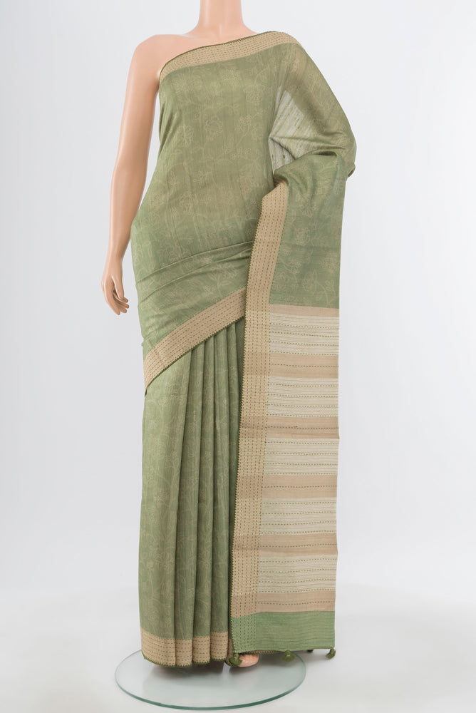 Pure Silk Pure Zari Pista Green Tussar Saree with Floral Print on the body and Silk Border.  displayed on a mannequin