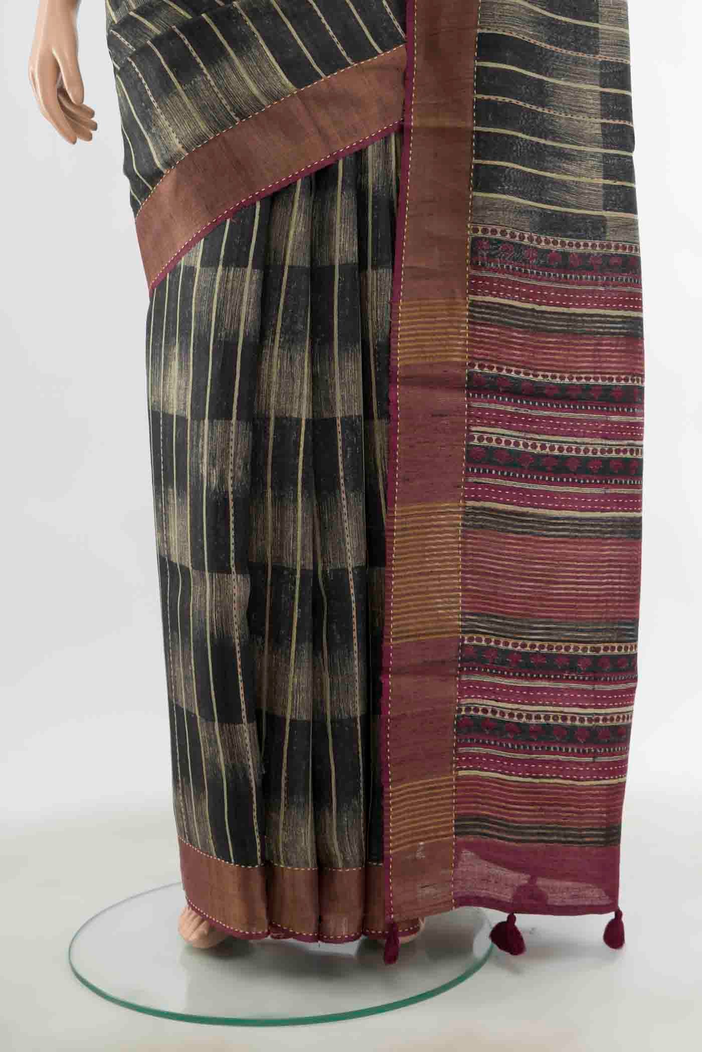 Pleats and pallu of Black Tussar Silk Saree with Zari Butta on the body and Silk Border